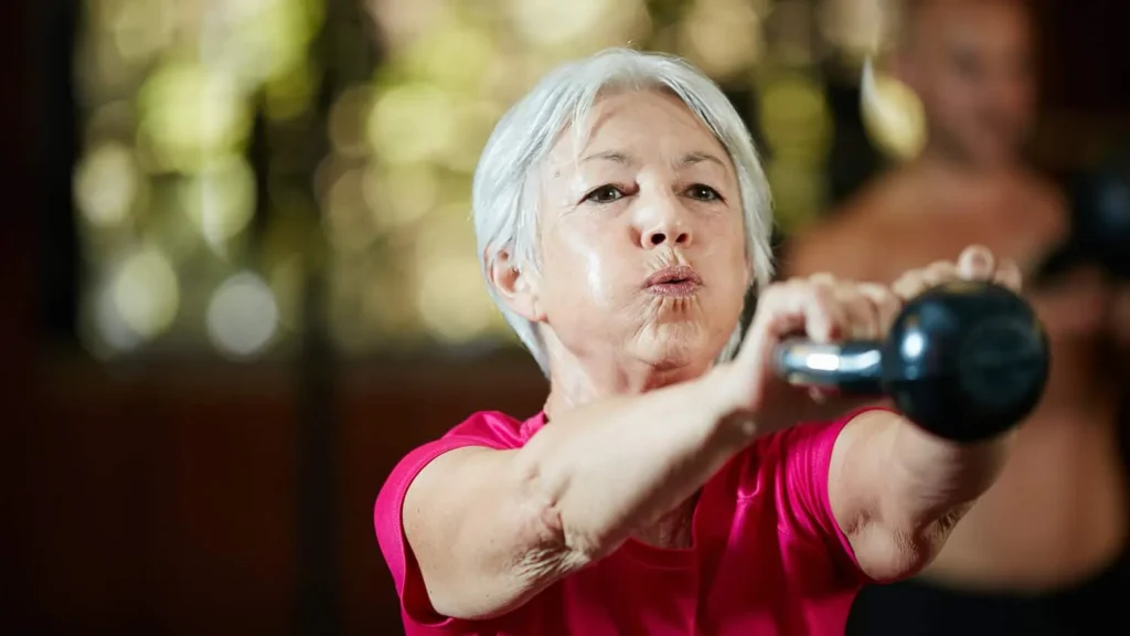Toning Arms Without the Bulk: Is It Achievable? 1 Woman doing resistance band exercises for toned arms Sunbury